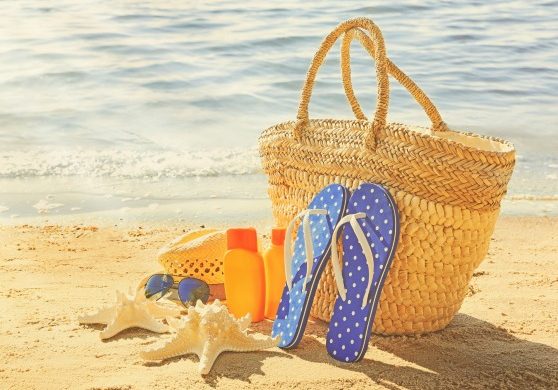 Sun protection set on beach. Skin care concept.